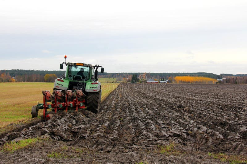 Tractor and plough on a Field in Autumn