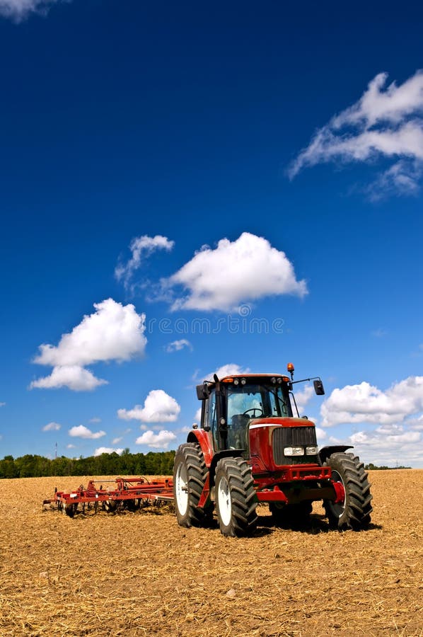 Tractor in plowed field royalty free stock photography