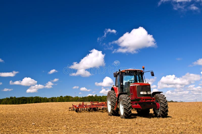 Tractor in plowed field royalty free stock photography