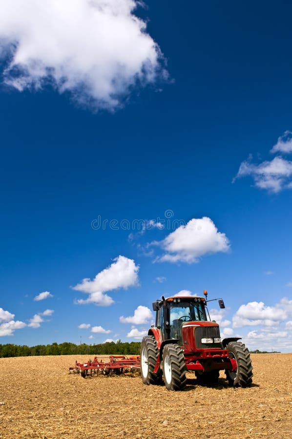 Tractor in plowed field stock photos