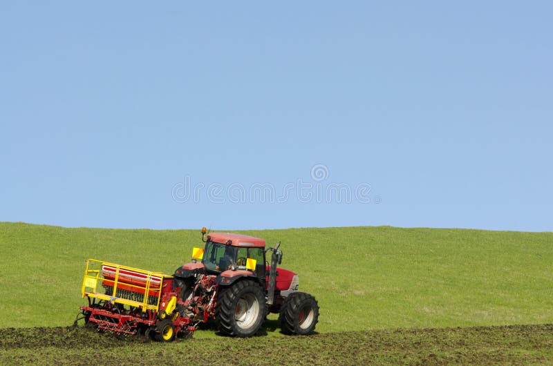 Tractor plowing the ground royalty free stock images