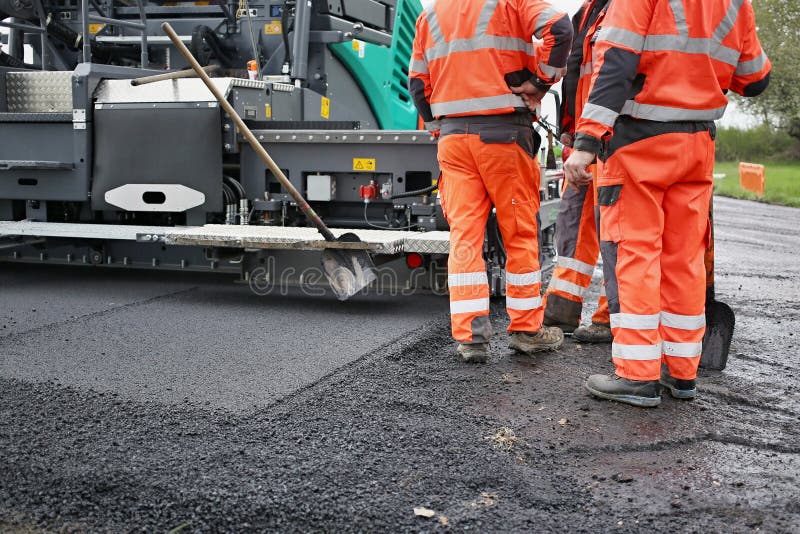 Tractor, roller on the road repair site. Road construction equipment. Road repair concept. Construction workers on road repair.