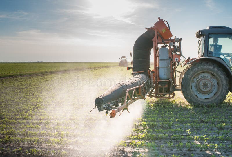 Tractor spraying pesticides royalty free stock images