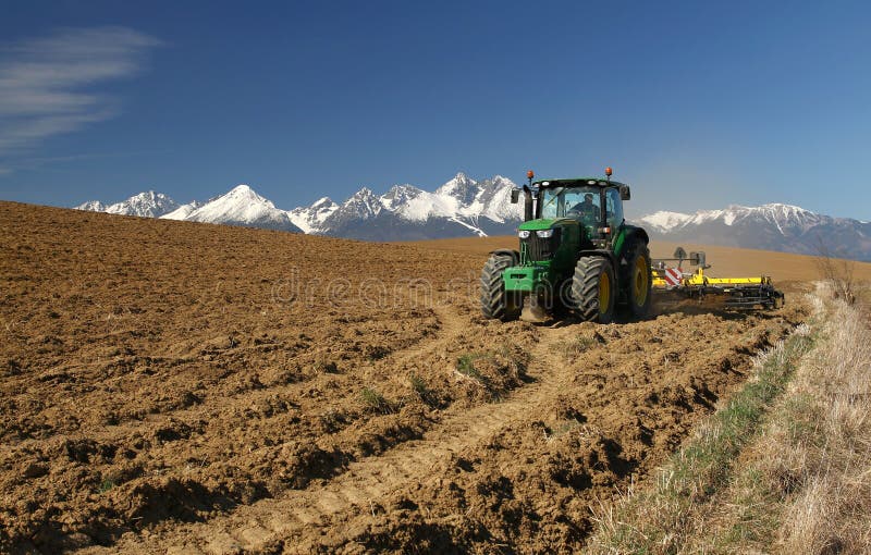 Tractor under mountains