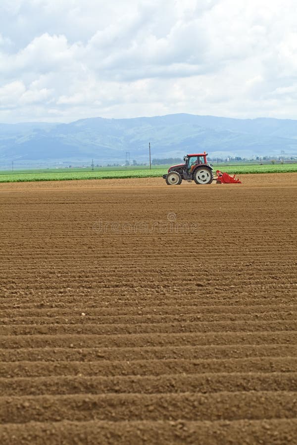 Tractor working in the field royalty free stock photo