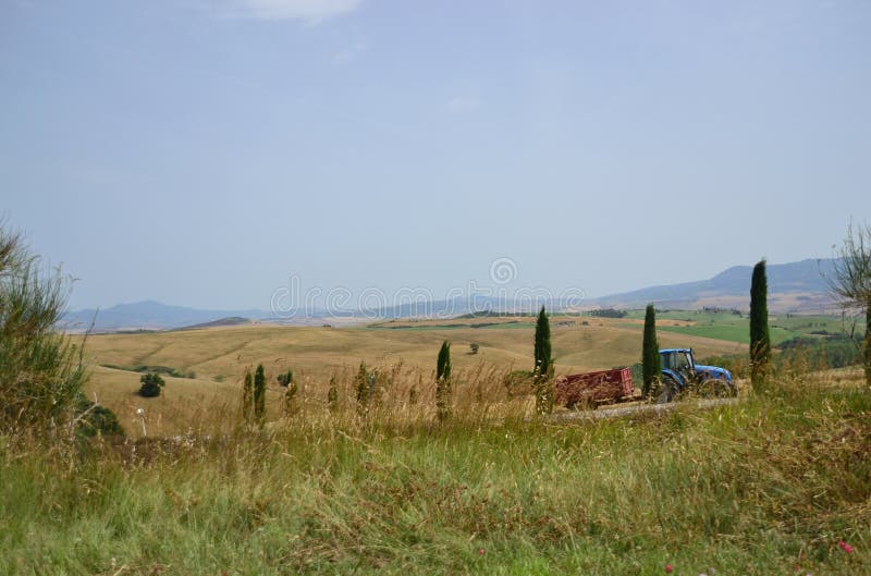 Tractor working in Tuscany, Italy stock photos