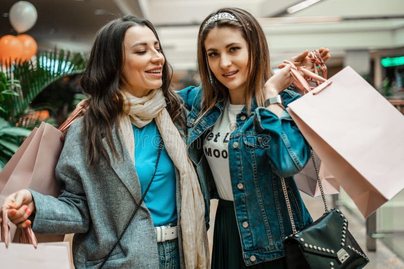 Trade, Buyers. Two Beautiful Girls Make Purchases in a Shopping Center ...