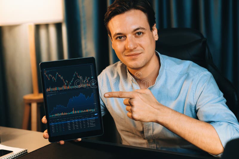 Trader in casual looking at camera stock with pointing laptop. Pecuniary. stock images