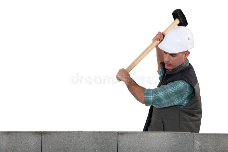 Tradesman using a mallet stock images