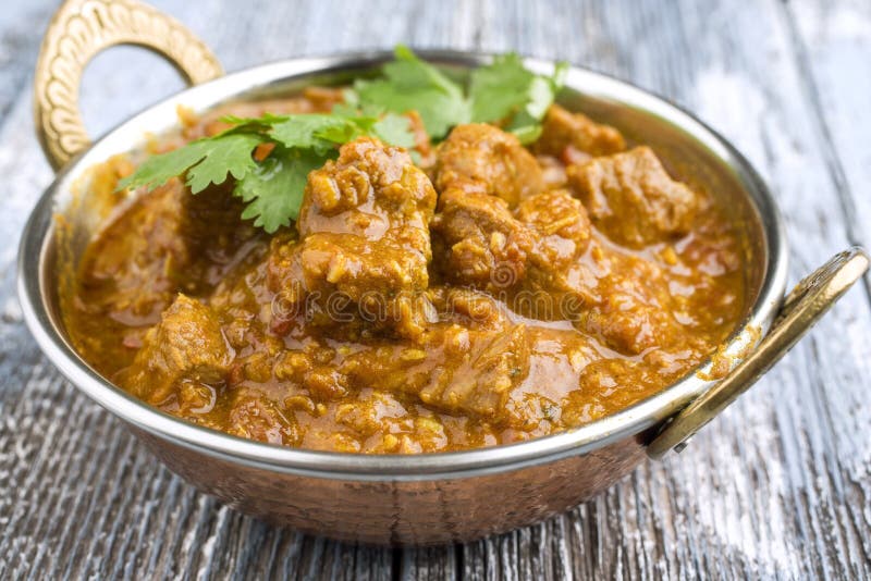 Traditinal Indian Lamb Curry offered in a rustic Korai