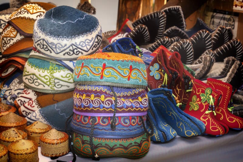 Traditional Asian headdresses from a multicolored felt with an embroidered colored thread of national ornament. Selective focus.