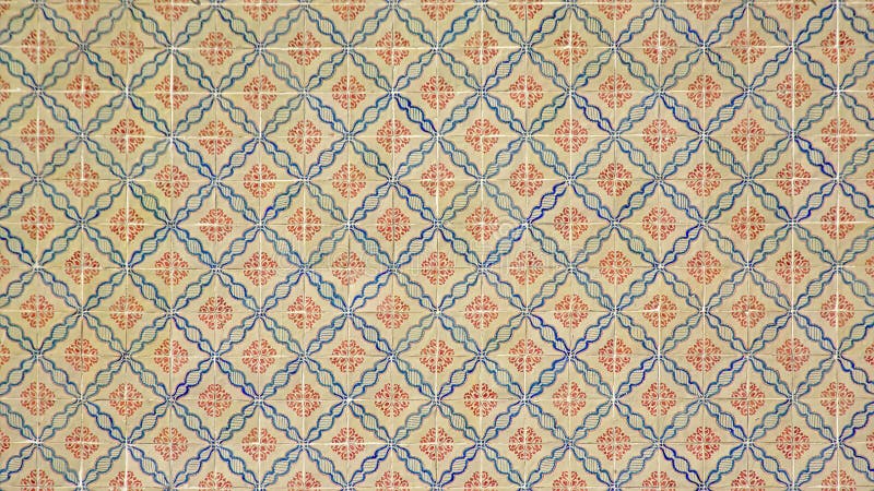 Traditional azulejos glazed tiles with semi-abstract floral pattern in blue and red from Lisbon, Portugal. Traditional azulejos glazed tiles with semi-abstract floral pattern in blue and red from Lisbon, Portugal