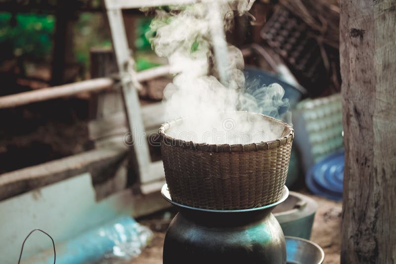 Traditional Bamboo steamer pot to boil water for cooking sticky rice with smoke