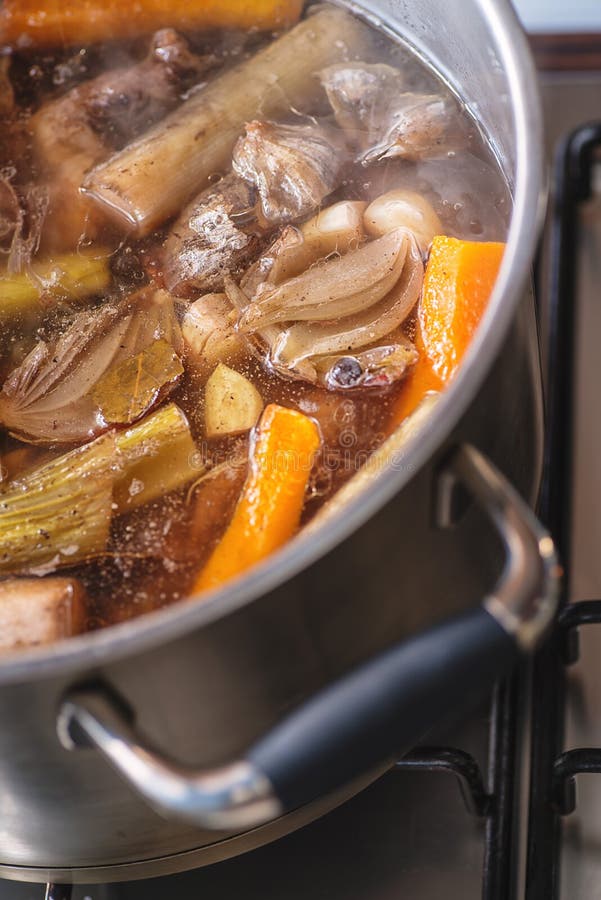 Traditional Beef Broth with Vegetable, Bones and Ingredients in Pot