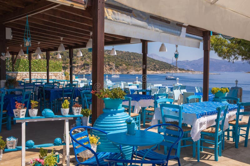 Traditional blue and white greek tavern with magnificent sea view in summer, Kastos island, Greece.