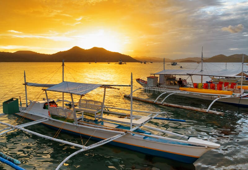Traditional boats at sunset. Philippines royalty free stock image