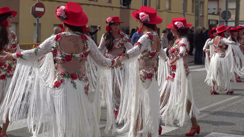 Traditional carnival in a Spanish town Palamos in Catalonia. Many people in costume and interesting make-up dancing on the street.