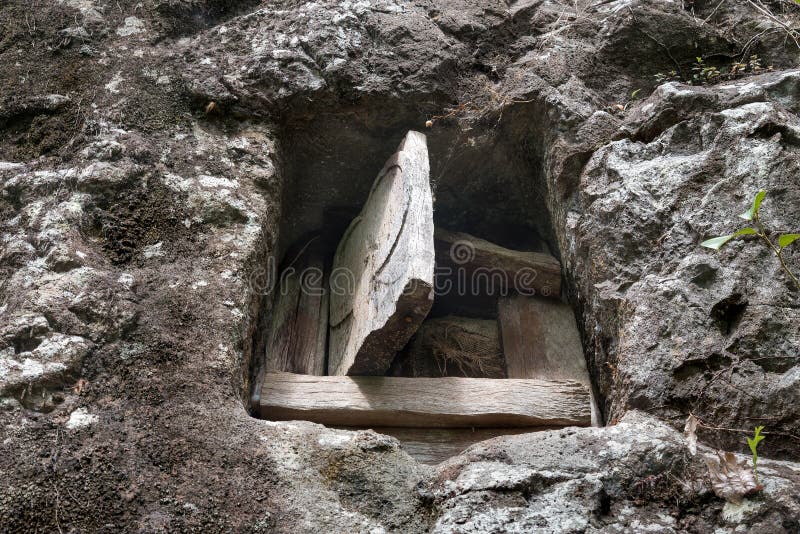 Traditional cave grave carved in the rock at Lemo. Tana Toraja, South Sulawesi, Indonesia stock image Traditional cave grave carved in the rock at Lemo. Tana Toraja, South Sulawesi, Indonesia stock image