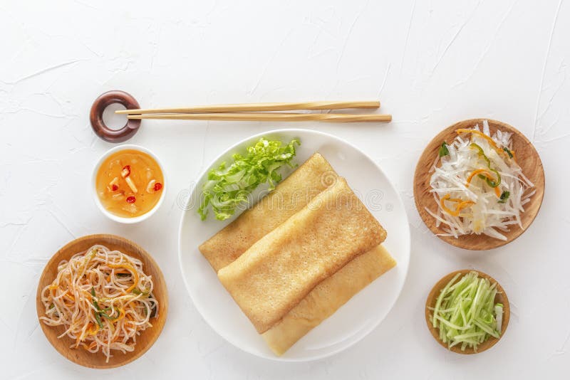 Traditional Chinese tortillas filled with bings in a plate on a white background, hot salads, Dam Sam snacks. royalty free stock image Traditional Chinese tortillas filled with bings in a plate on a white background, hot salads, Dam Sam snacks. royalty free stock image