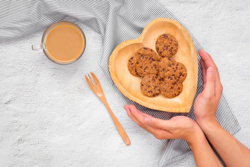 Traditional chocolate chip cookies on heart shape plate.