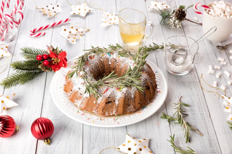 Traditional Christmas fruit cake on a white wooden table. Homemade pudding with festive decorations, candy canes royalty free stock image Traditional Christmas fruit cake on a white wooden table. Homemade pudding with festive decorations, candy canes royalty free stock image