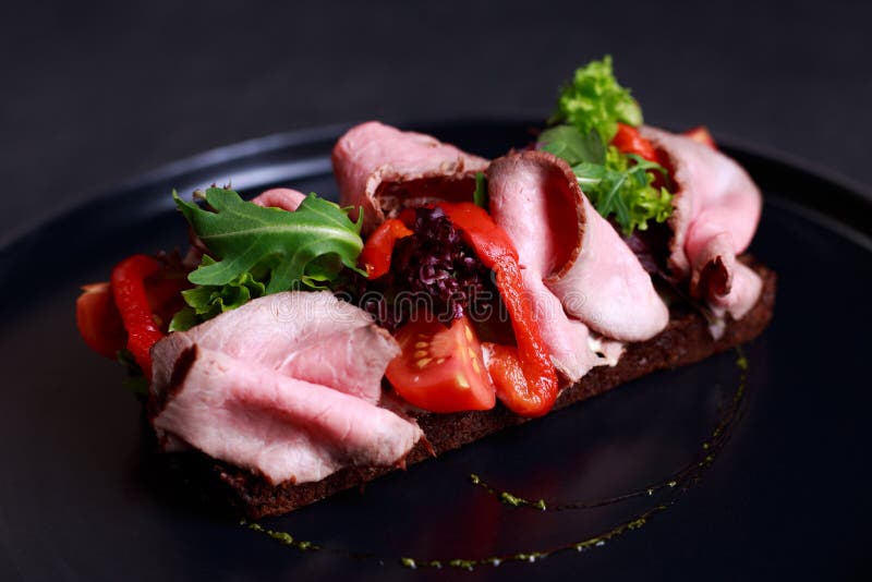 Traditional Danish Open Sandwich Smorrebrod with Roast Beef and Stock