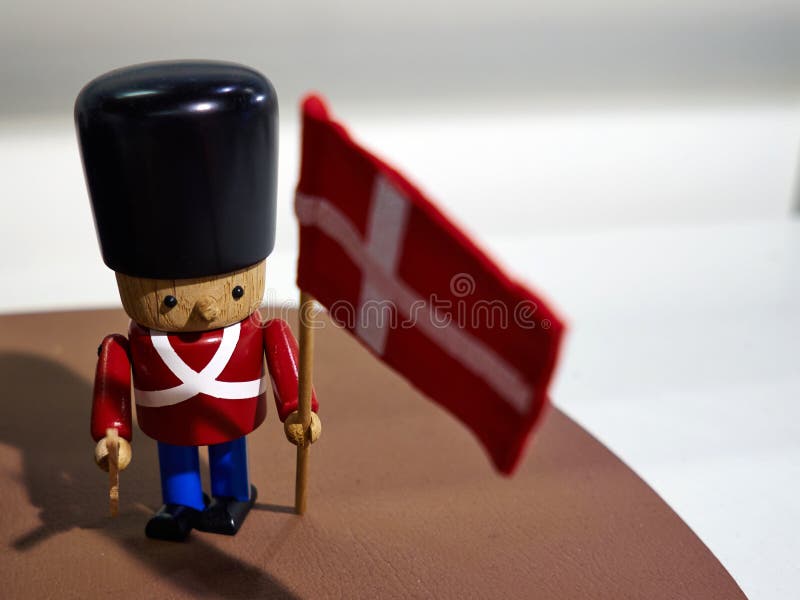 Traditional Danish Royal Guard toy soldier with flag of Denmark