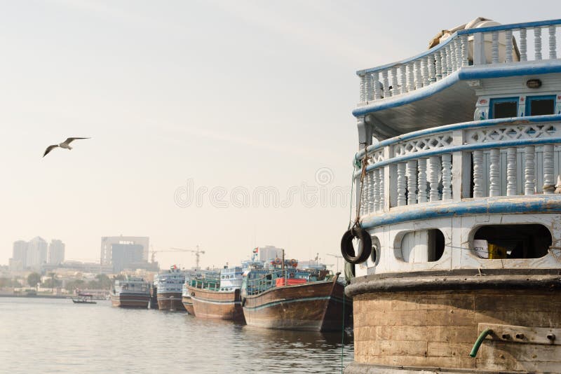 Traditional dhow boats moored up at dubai creek dubai, uae royalty free stock images