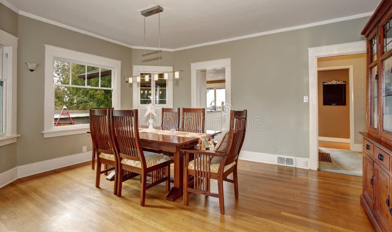 Traditional dinning room with hardwood floor, and hanging light