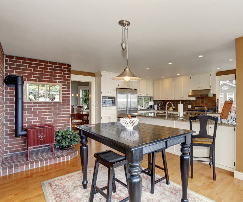 Traditional dinning room with hardwood floor, and hanging light