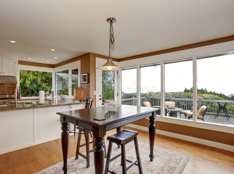 Traditional dinning room with hardwood floor, and hanging light