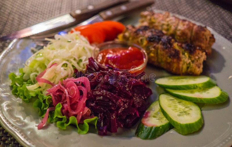 A Traditional Dish of Kebab on a Plate, Cooked on a Grill, Along with