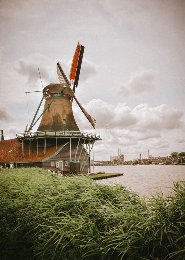 Traditional Dutch Windmill by the River stock photography