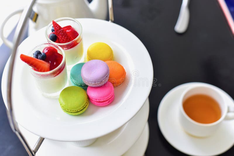 Traditional English Afternoon Tea Set with Colourful Macarons and Desserts stock photos Traditional English Afternoon Tea Set with Colourful Macarons and Desserts stock photos