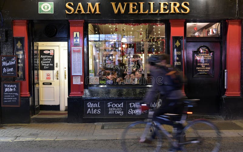 BATH, UK - DECEMBER 9, 2015: People drink at traditional English pub on a city centre street. The landmark Somerset city has a Unesco World Heritage status and receives 17 million visitors annually.