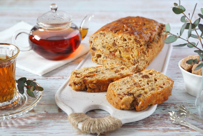 Traditional English tea raisins cake with candied orange, egg-free cake and cup of tea