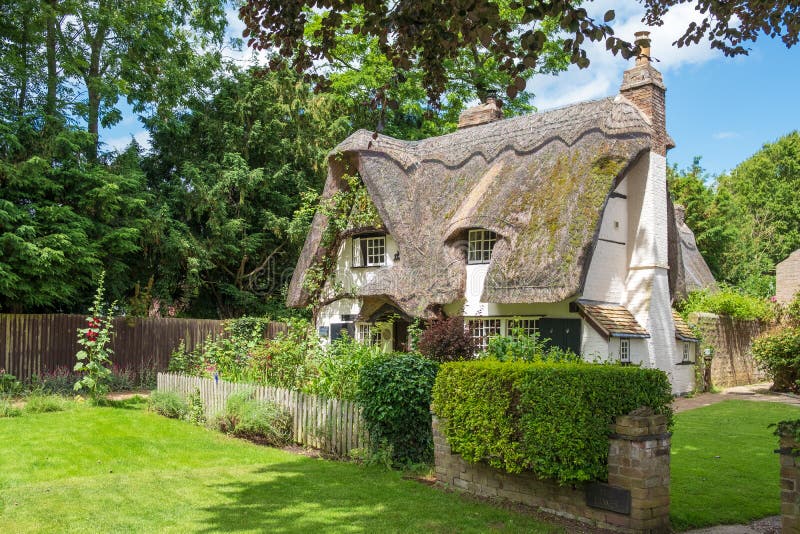 Traditional English, thatched roof cottages seen in a very well maintained condition.