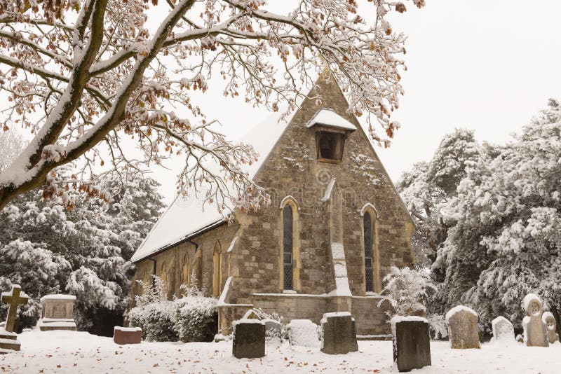 Traditional English village church covered in Snow.