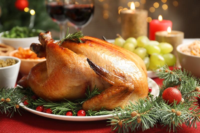 Golden roasted turkey with meat thermometer on table Stock Photo