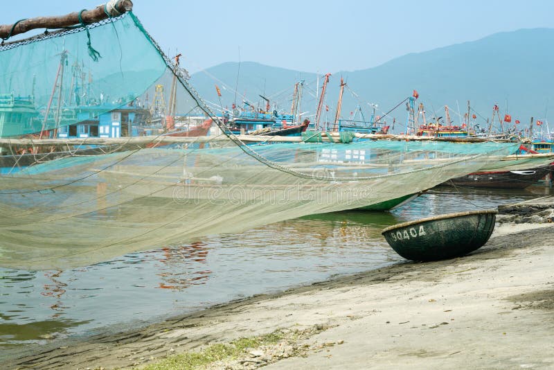 Traditional Fishing Boat with Net and Woven Bamboo Basket Boat At The Fishing Village in Da Nang, Vietnam stock photos Traditional Fishing Boat with Net and Woven Bamboo Basket Boat At The Fishing Village in Da Nang, Vietnam stock photos