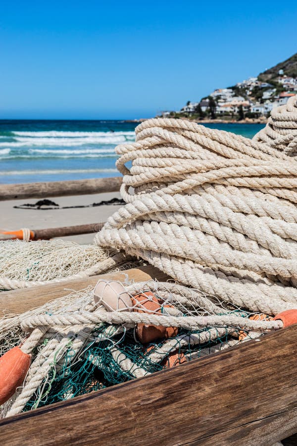 Traditional Fishing Net on Small Rowing Boat on Beach Stock Photo