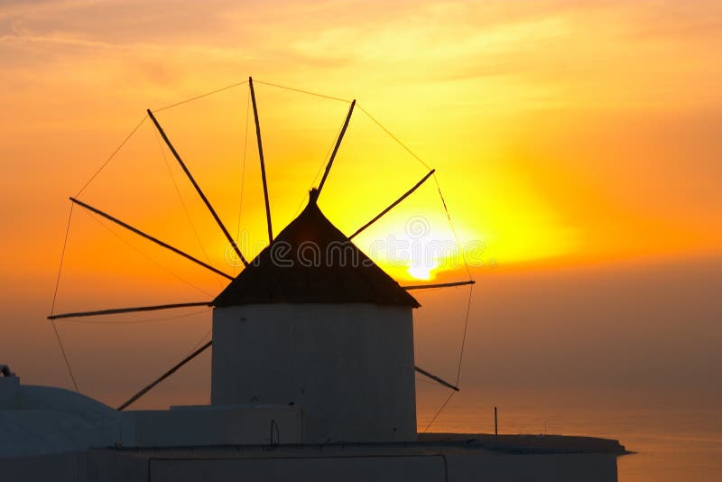 Traditional greek village, Oia, Santorini, sunset with winmill