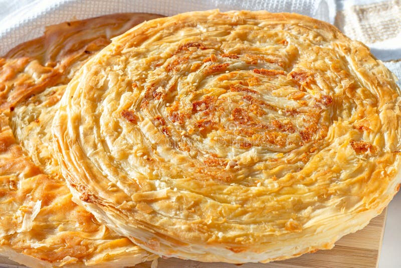 Traditional homemade Tajik Fatir (layered flat bread) with cheese and onion on light wooden background stock photo Traditional homemade Tajik Fatir (layered flat bread) with cheese and onion on light wooden background stock photo