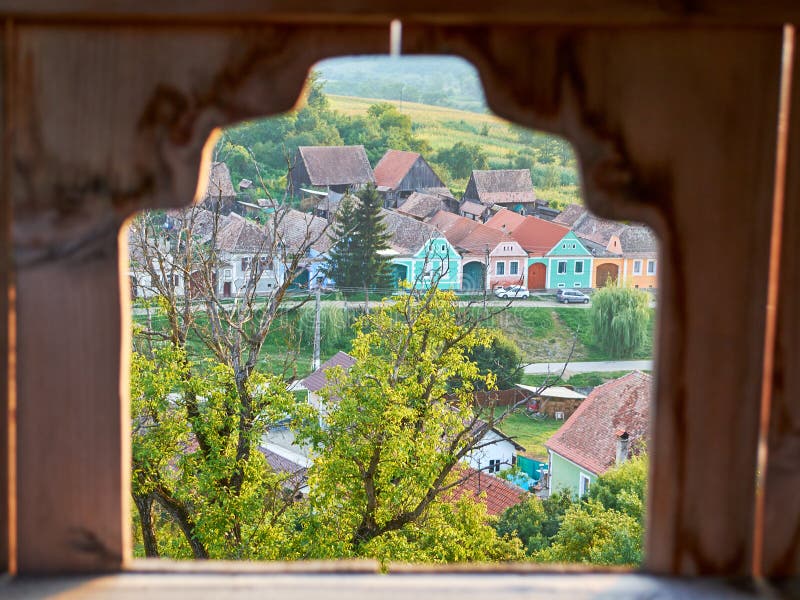 Traditional houses in Transylvania, Romania, seen through a frame in the Alma Vii fortified church stone wall stock photos Traditional houses in Transylvania, Romania, seen through a frame in the Alma Vii fortified church stone wall stock photos