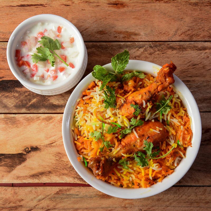 Traditional Hyderabadi Chicken dhum Biryani made of Basmati rice cooked with masala spices, served with raita, selective focus. Chicken dum biryani stock images, royalty-free photos and pictures
