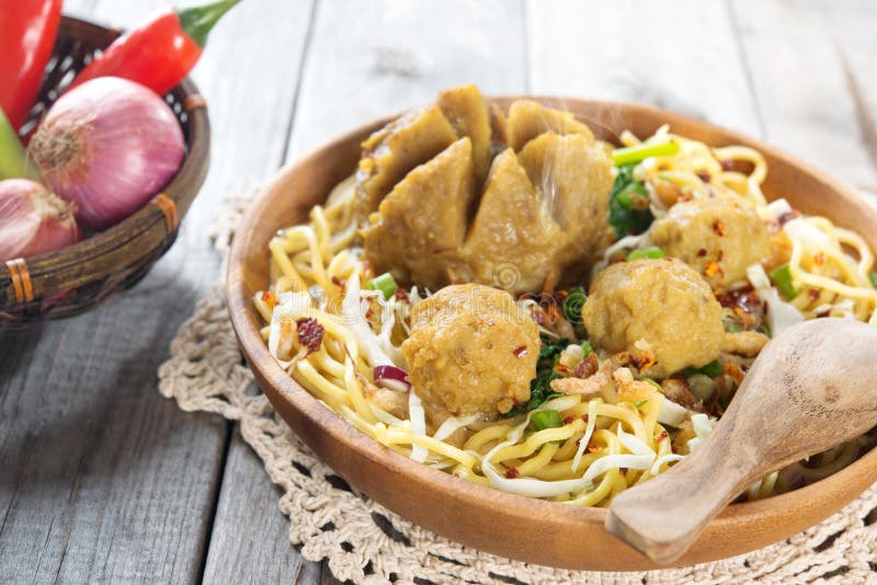 Indonesian meatball noodles or mee bakso, popular Indonesian street food. Fresh hot with steam smoke. Indonesian meatball noodles or mee bakso, popular Indonesian street food. Fresh hot with steam smoke.