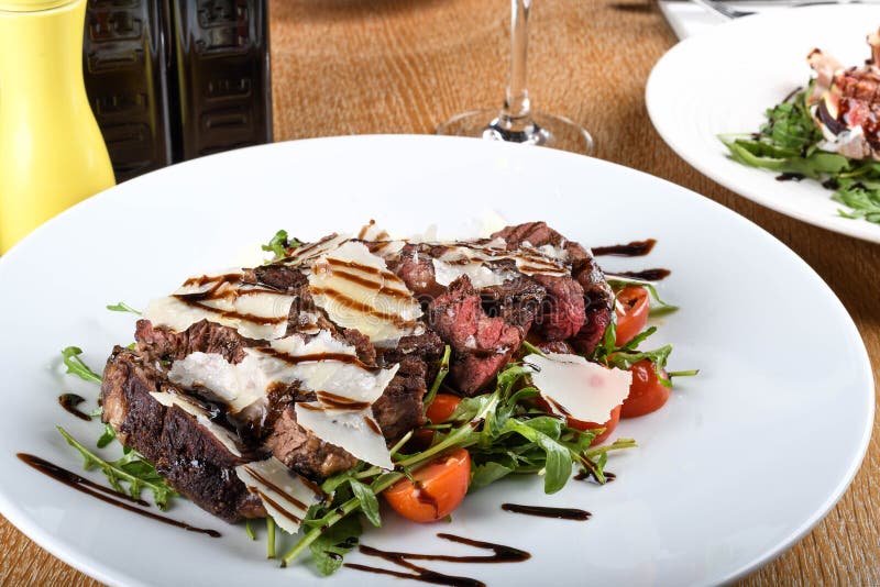 Traditional Italian Main Dish. Beef Tagliata Tender Beef Rib Eye, Arugula, Cherry Tomatoes