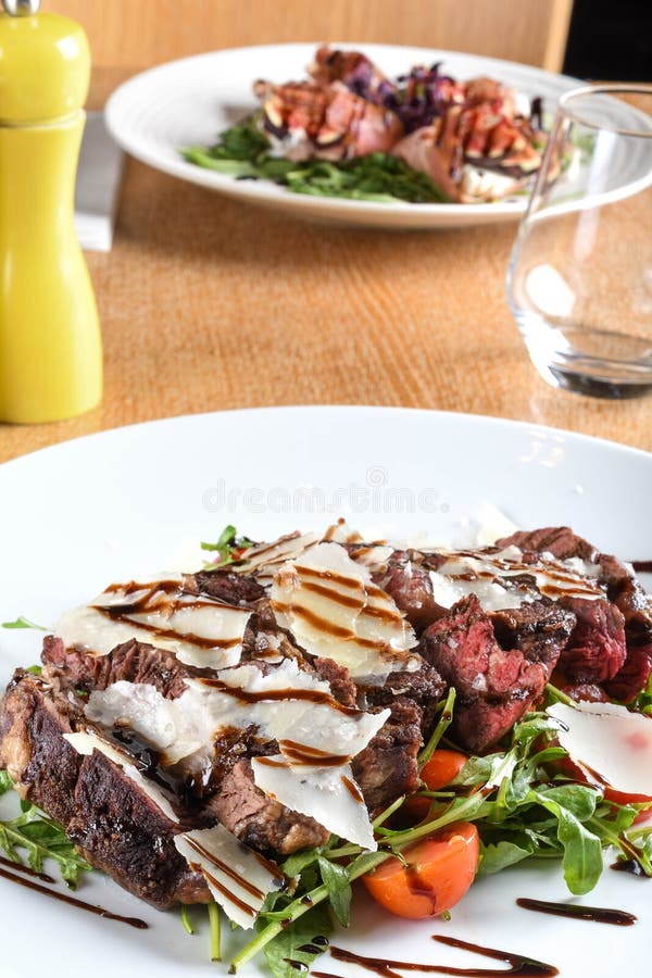 Traditional Italian Main Dish. Beef Tagliata Tender Beef Rib Eye, Arugula, Cherry Tomatoes