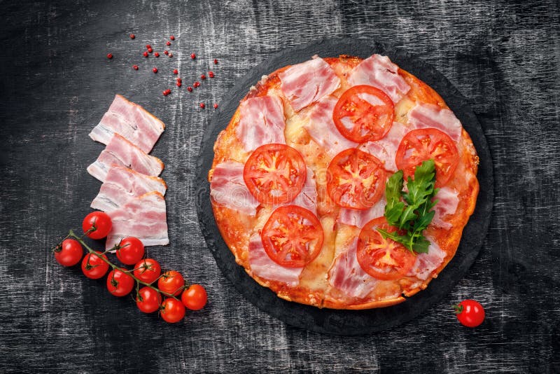 Traditional italian pizza with mozzarella cheese, ham, tomatoes royalty free stock photo Traditional italian pizza with mozzarella cheese, ham, tomatoes royalty free stock photo