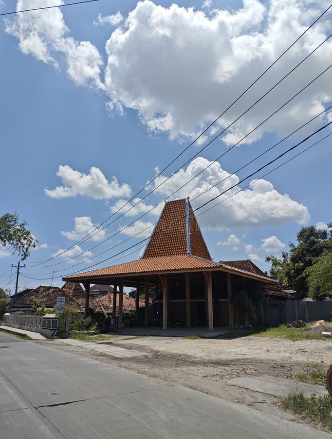 Traditional Javanese Building Along Rural Road Under Blue Sky royalty free stock images
